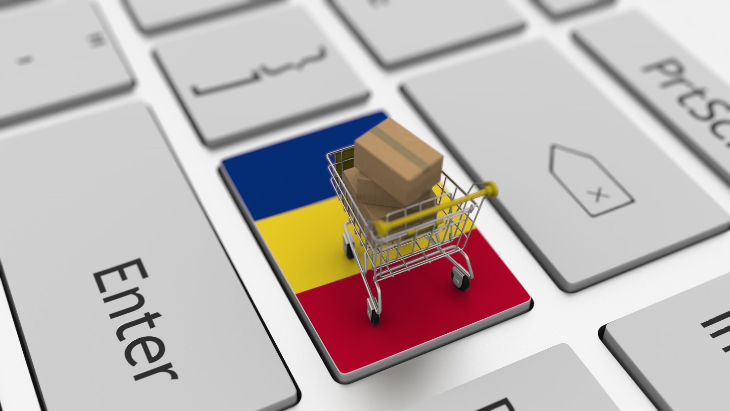 pulpit laptopa z rumunska flaga i koszykiem z zakupami