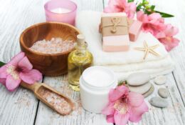 Spa cosmetics with alstroemeria flowers on a wooden background